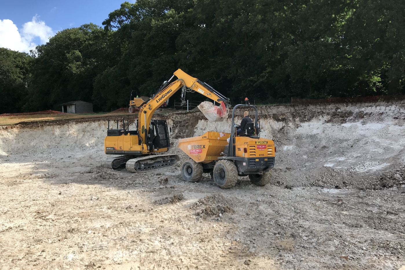 Excavator loading a dumper on a bulk excavation in chalk