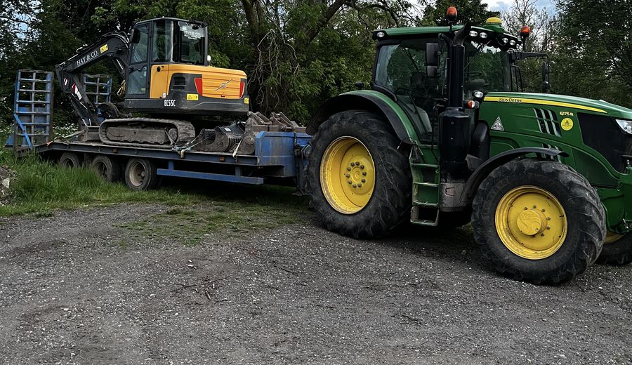 Excavator loaded on a trailer ready to move to site