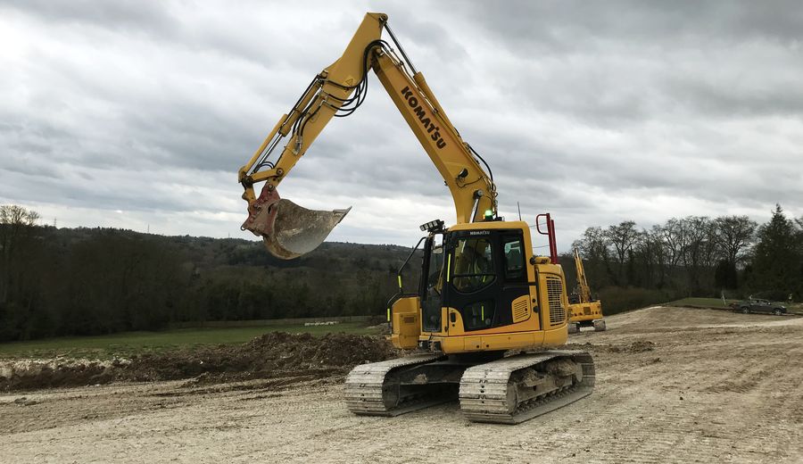 Large tracked excavator working a haul road and site strip